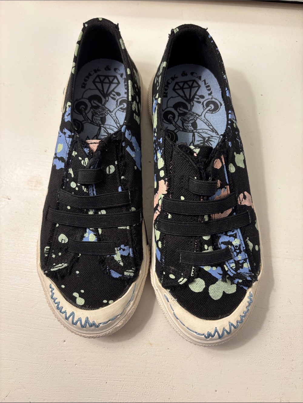 Rock & Candy Black Canvas Slip-On Sneakers with Blue, Green & Pink Splatter